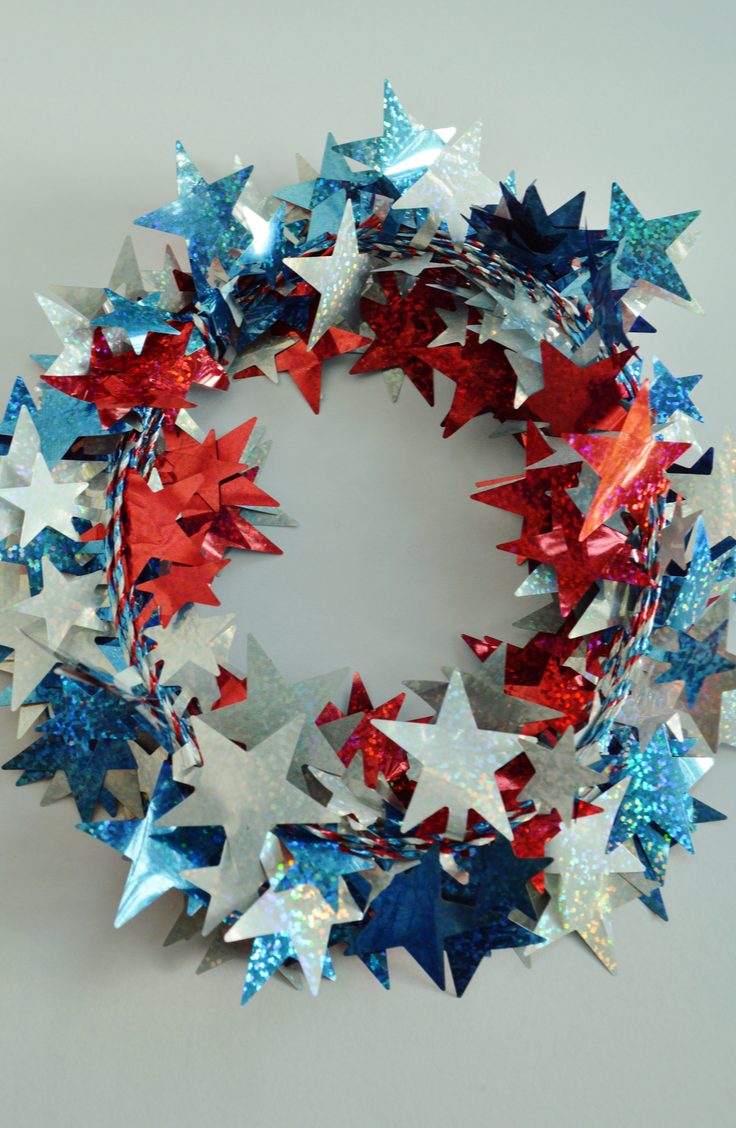 Make your door a shining star this summer with an easy wreath made with glittery star garland. Here are some darling ideas for 4th of July DIY door wreaths. You will love them!
